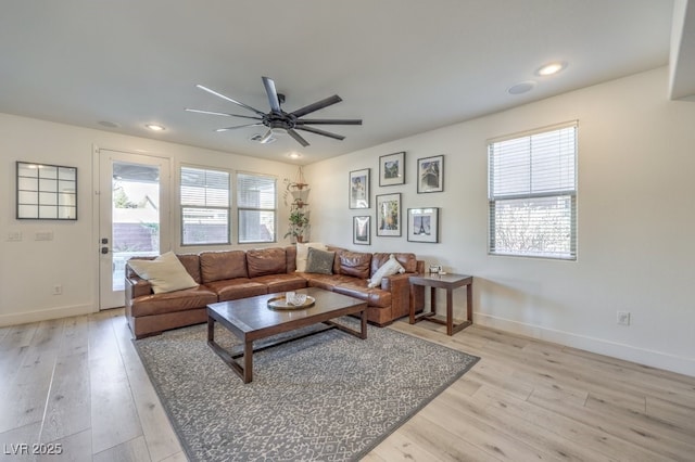 living room featuring ceiling fan and light hardwood / wood-style floors