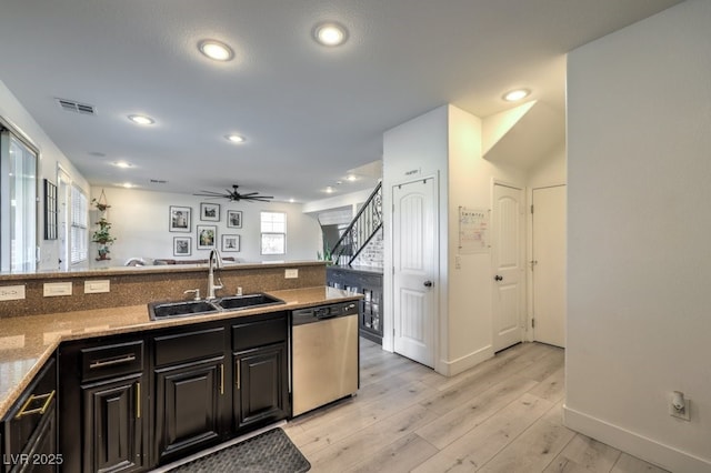 kitchen featuring ceiling fan, sink, dishwasher, and light wood-type flooring