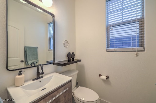 bathroom featuring toilet and vanity