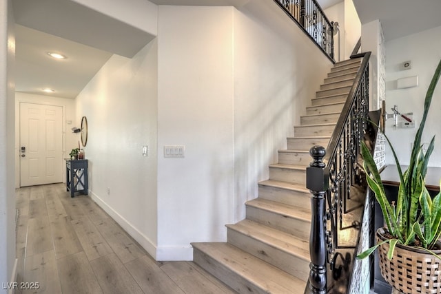 staircase with wood-type flooring