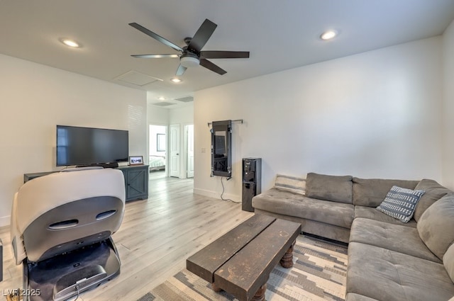 living room with ceiling fan and light wood-type flooring