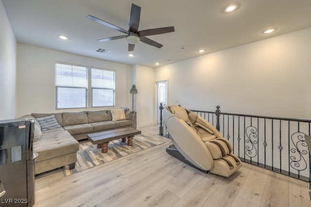 living room featuring ceiling fan and light hardwood / wood-style floors