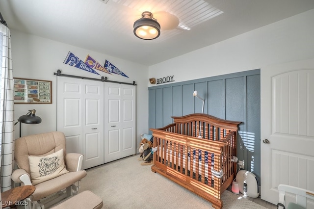 bedroom featuring carpet, a closet, and a crib