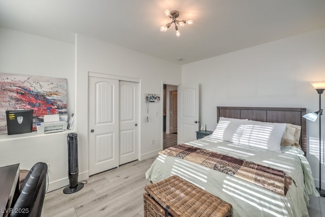 bedroom with a closet and light hardwood / wood-style floors