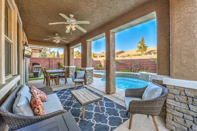 view of patio with grilling area, ceiling fan, and a fenced in pool