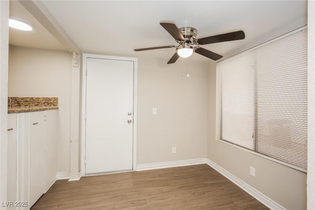 unfurnished room with ceiling fan and hardwood / wood-style floors