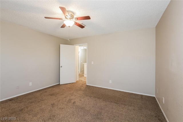 spare room featuring carpet floors, a textured ceiling, and ceiling fan