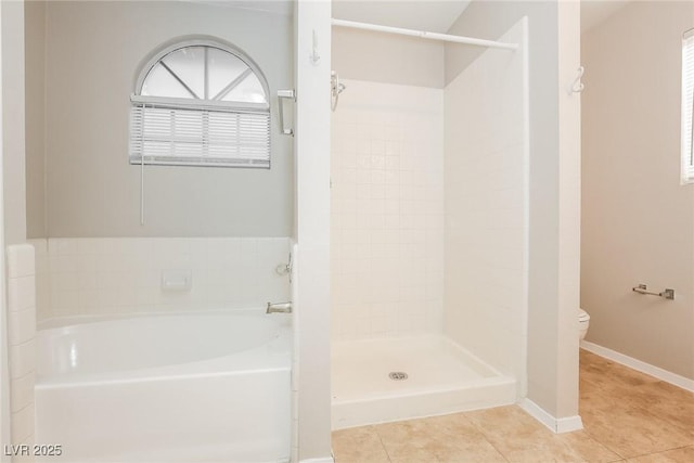 bathroom featuring toilet, tile patterned floors, and plus walk in shower