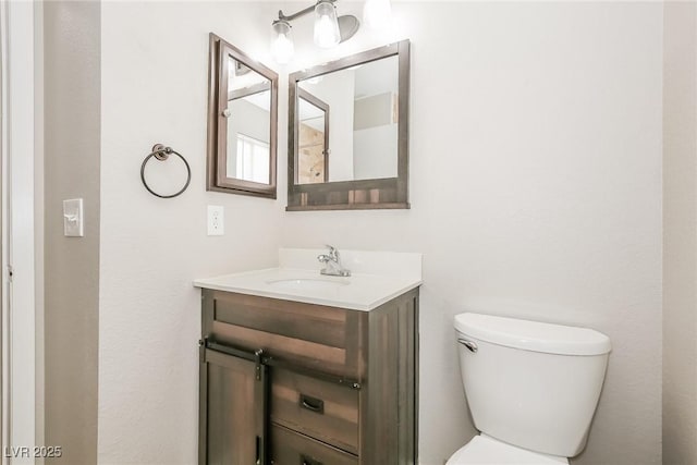 bathroom with toilet and vanity