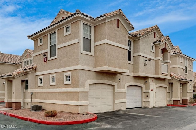 view of building exterior with a garage and driveway