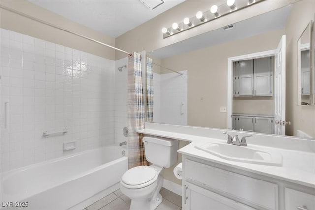 full bathroom featuring tile patterned floors, vanity, toilet, and shower / bath combination with curtain