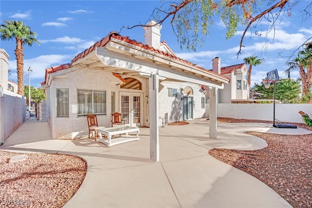 back of property featuring french doors and a patio