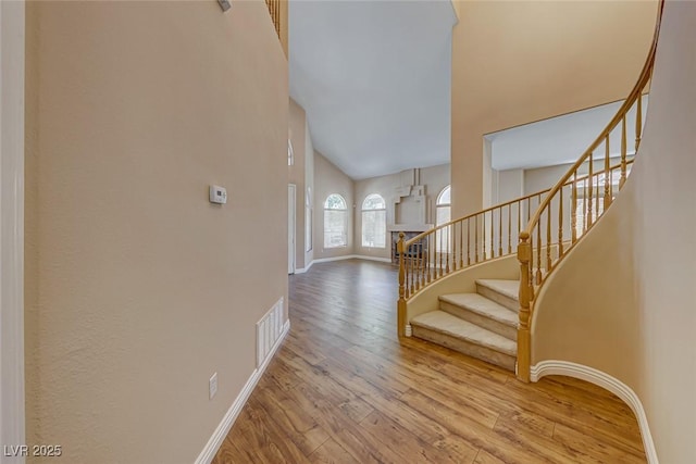 foyer with a high ceiling and hardwood / wood-style floors