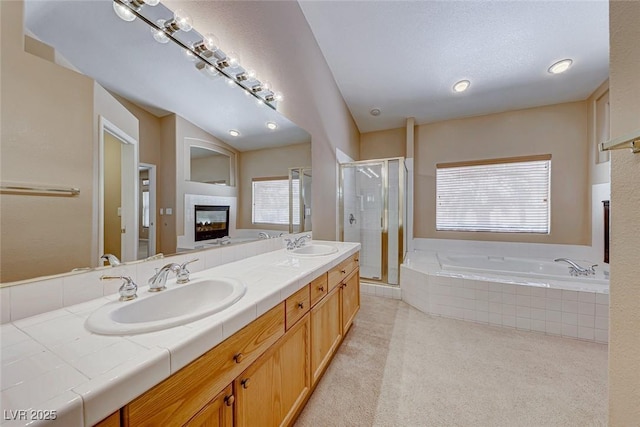 bathroom with shower with separate bathtub and vanity