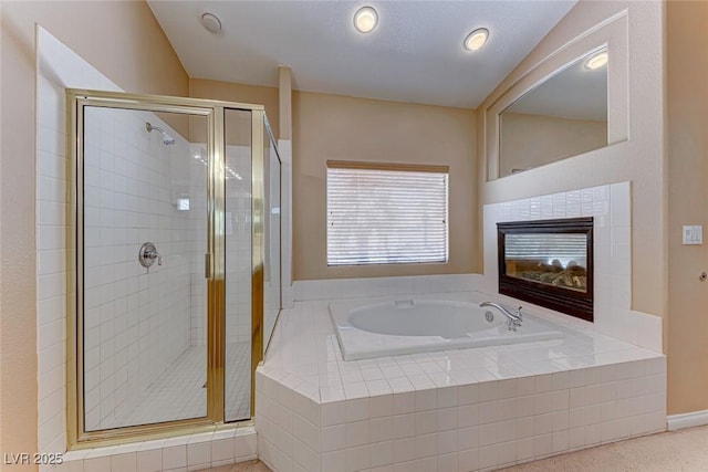 bathroom with shower with separate bathtub and a tile fireplace