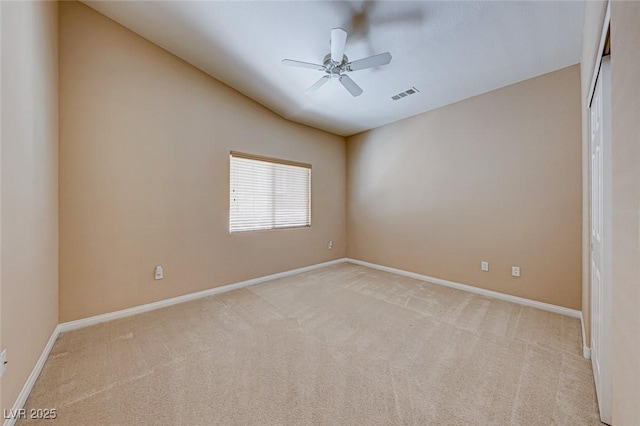 empty room featuring light carpet, ceiling fan, and lofted ceiling