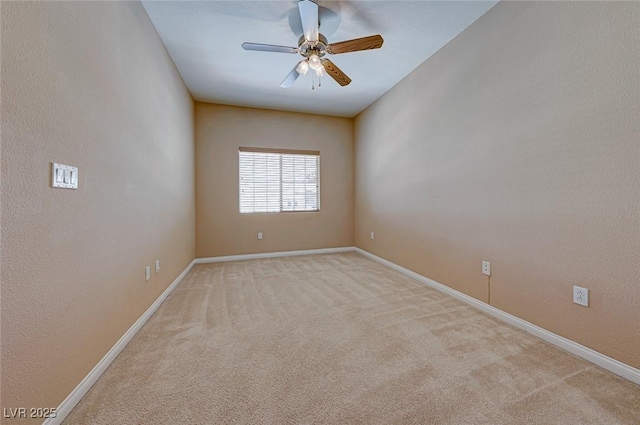 carpeted spare room with ceiling fan