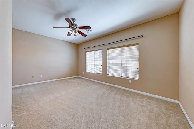 empty room with ceiling fan and light colored carpet