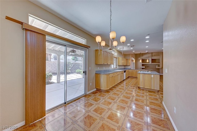 kitchen with a notable chandelier, pendant lighting, light brown cabinets, and a center island