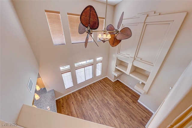 unfurnished living room with ceiling fan and hardwood / wood-style flooring