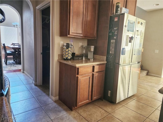 kitchen featuring stainless steel refrigerator and light tile patterned flooring