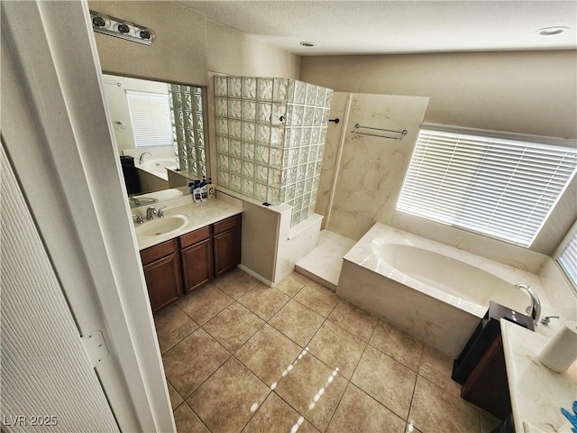 bathroom featuring tile patterned floors, separate shower and tub, and vanity