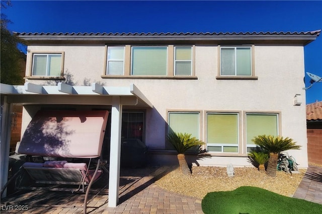 rear view of property featuring a patio area