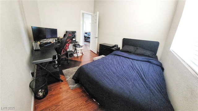 bedroom with dark hardwood / wood-style floors