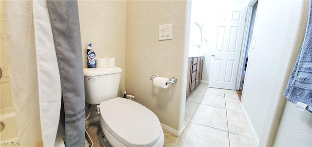 bathroom with toilet and tile patterned flooring