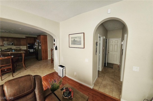 hall with heating unit and light tile patterned floors