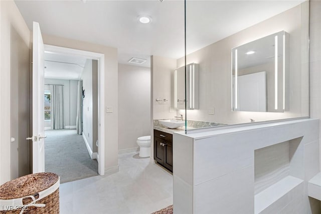 bathroom featuring toilet and vanity