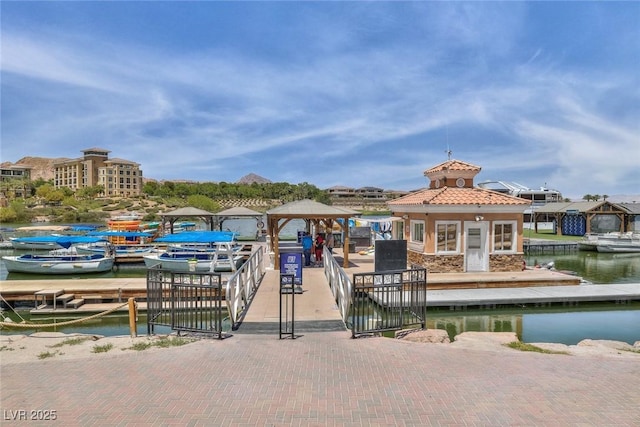 view of dock with a gazebo and a water view