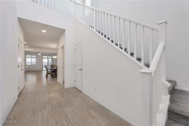 stairway with ceiling fan