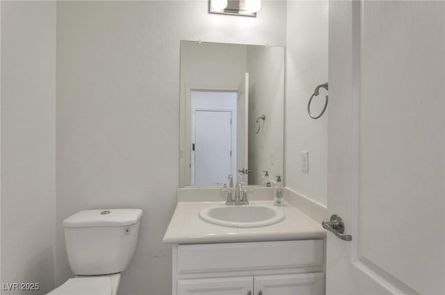 bathroom with toilet and vanity