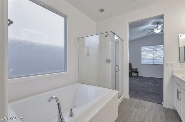 bathroom with lofted ceiling, vanity, ceiling fan, and independent shower and bath