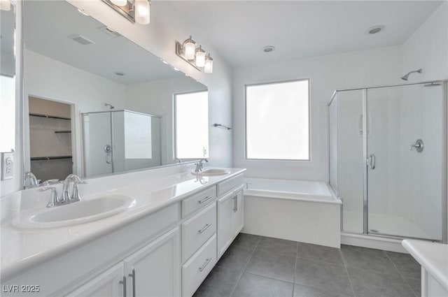 bathroom featuring plenty of natural light, plus walk in shower, and tile patterned flooring