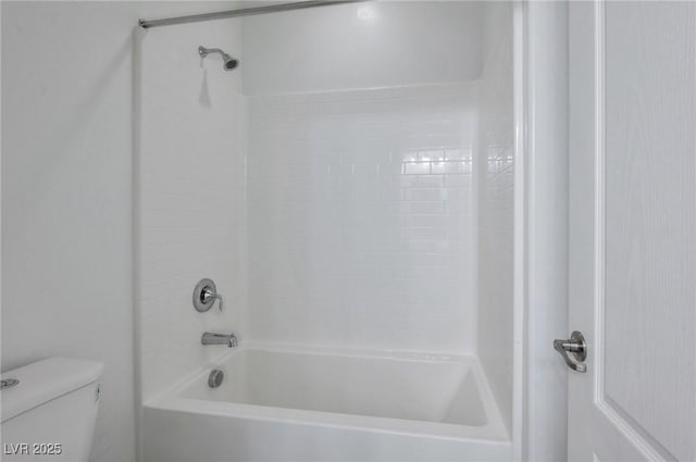 bathroom with toilet and bathtub / shower combination