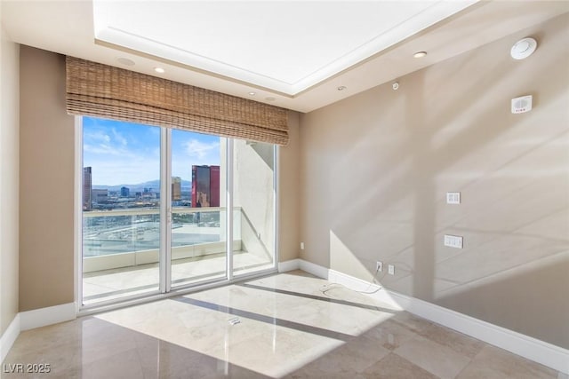 spare room featuring a raised ceiling