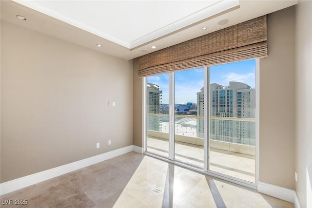 unfurnished room with a raised ceiling