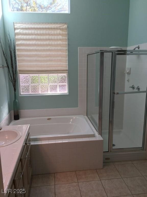 bathroom featuring plus walk in shower, tile patterned floors, and vanity