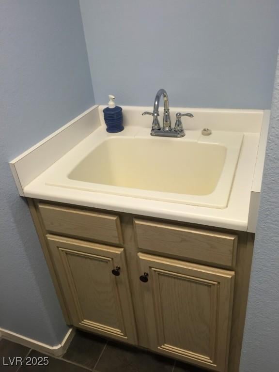 bathroom with tile patterned flooring and vanity