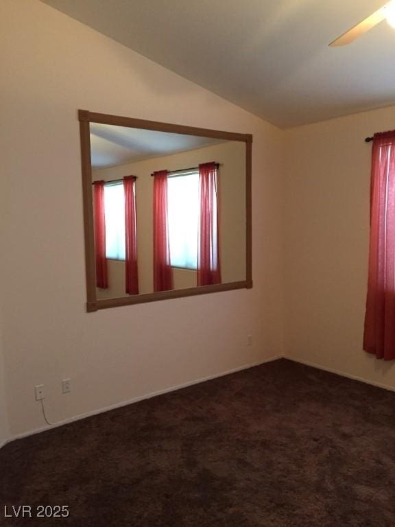 carpeted empty room with ceiling fan and lofted ceiling