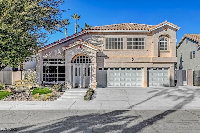 mediterranean / spanish home featuring a garage