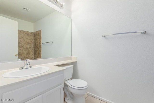 bathroom with toilet, tile patterned floors, and vanity