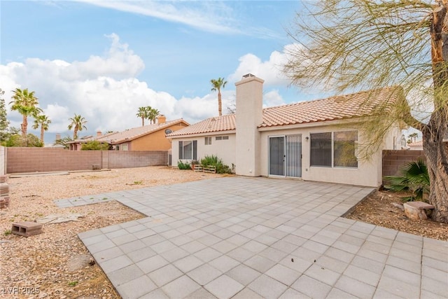 back of property with a patio