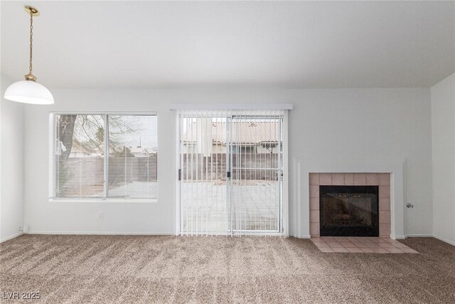 unfurnished living room with a fireplace and carpet flooring