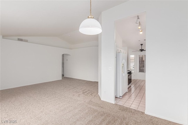 spare room with light carpet, ceiling fan, and lofted ceiling