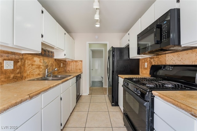 kitchen with white cabinetry, sink, track lighting, and black appliances