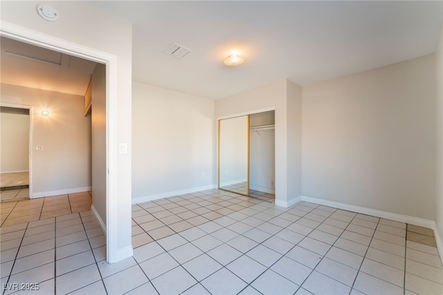 unfurnished bedroom featuring a closet and light tile patterned flooring