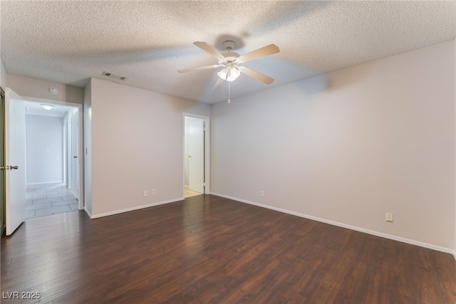 unfurnished room with ceiling fan, dark hardwood / wood-style flooring, and a textured ceiling